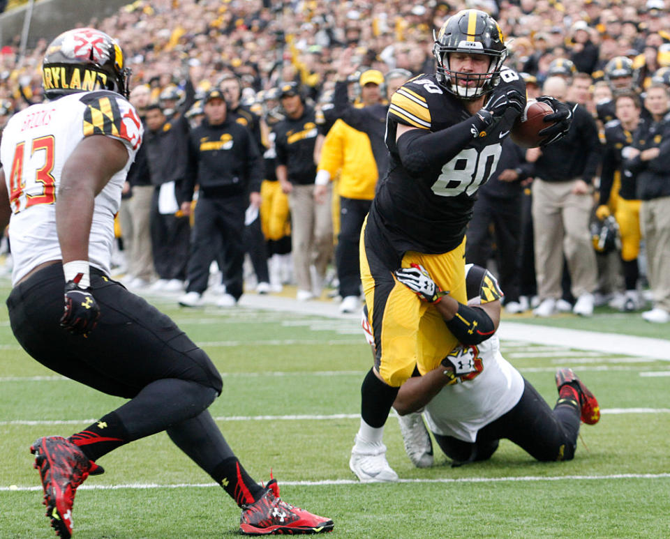 IOWA CITY, IA - OCTOBER 31: Tight end Henry Krieger Coble #80 of the Iowa Hawkeyes is brought down by linebacker Jalen Brooks #43 and Jermaine Carter #23 of the Maryland Terrapins in the first half on October 31, 2015 at Kinnick Stadium, in Iowa City, Iowa. (Photo by Matthew Holst/Getty Images)