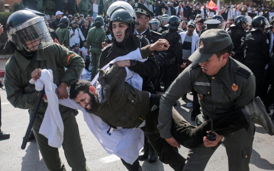 Security forces detain a protesting teacher during a demonstration in Rabat, Morocco on Wednesday - AP