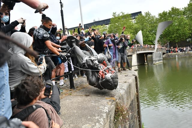 Protesters throw a statue of Edward Colston into Bristol harbour