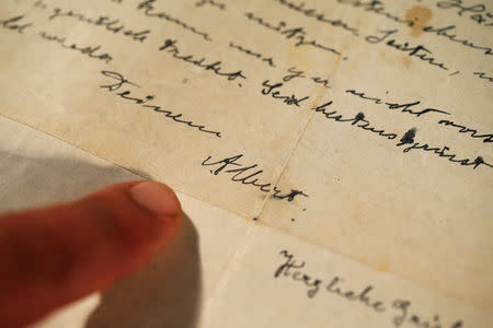 Meron Eren from Kedem Auction House shows a letter written in 1922 by physicist Albert Einstein, prior to its auction, in Jerusalem November 12, 2018. Picture taken November 12, 2018. REUTERS/Ronen Zvulun