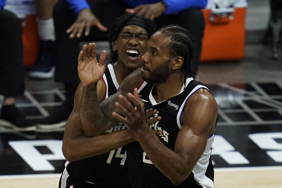 Los Angeles Clippers guard Terance Mann (14) and forward Kawhi Leonard (2) celebrate a shot during the fourth quarter of Game 7 of an NBA basketball first-round playoff series against the Dallas Mavericks Sunday, June 6, 2021, in Los Angeles, Calif. (AP Photo/Ashley Landis)