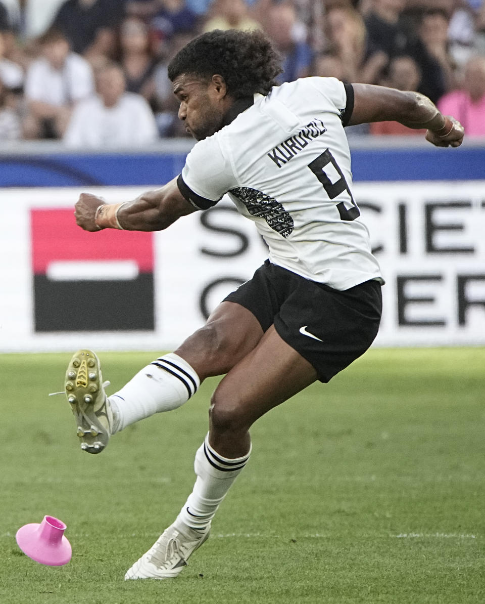 Fiji's Simione Kuruvoli kicks the ball during the Rugby World Cup Pool C match between Australia and Fiji at the Stade Geoffroy Guichard in Saint-Etienne, France, Sunday, Sept. 17, 2023. (AP Photo/Laurent Cipriani)