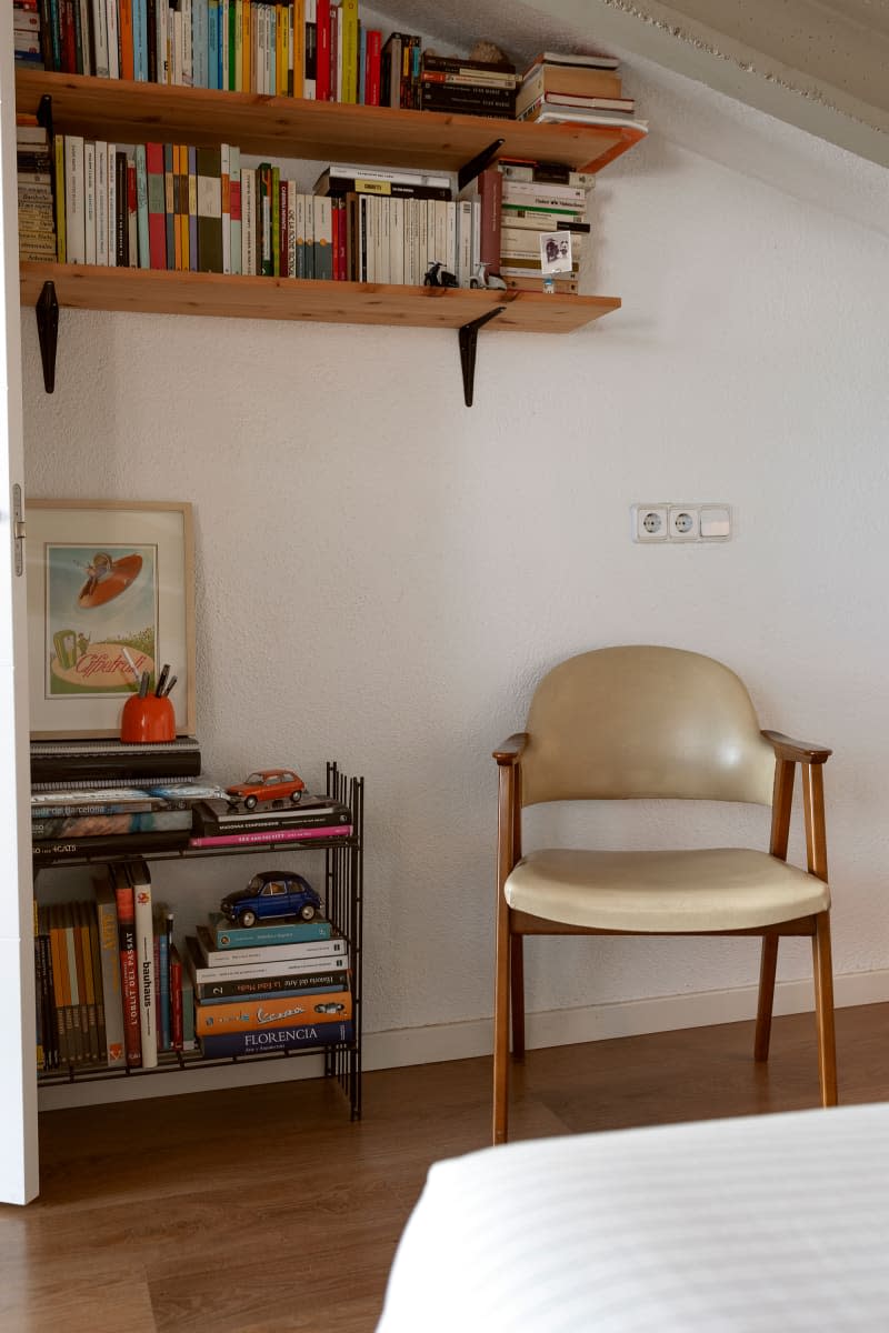 Chair and bookshelves in neutral toned room.