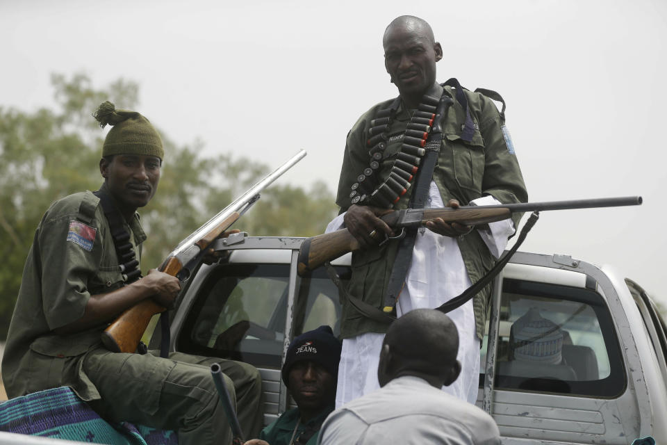 Vigilantes and local hunters armed with locally made guns patrol on the street near the Independent National Electoral Commission office in Yola, Nigeria, Monday Feb. 25, 2019. Official results of Nigeria's presidential election are expected as early as Monday in what is being seen as a close race between Incumbent President Muhammadu Buhari and opposition candidate Atiku Abubakar (AP Photo/Sunday Alamba)