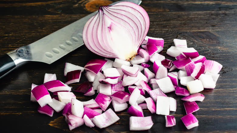 A knife next to diced onions