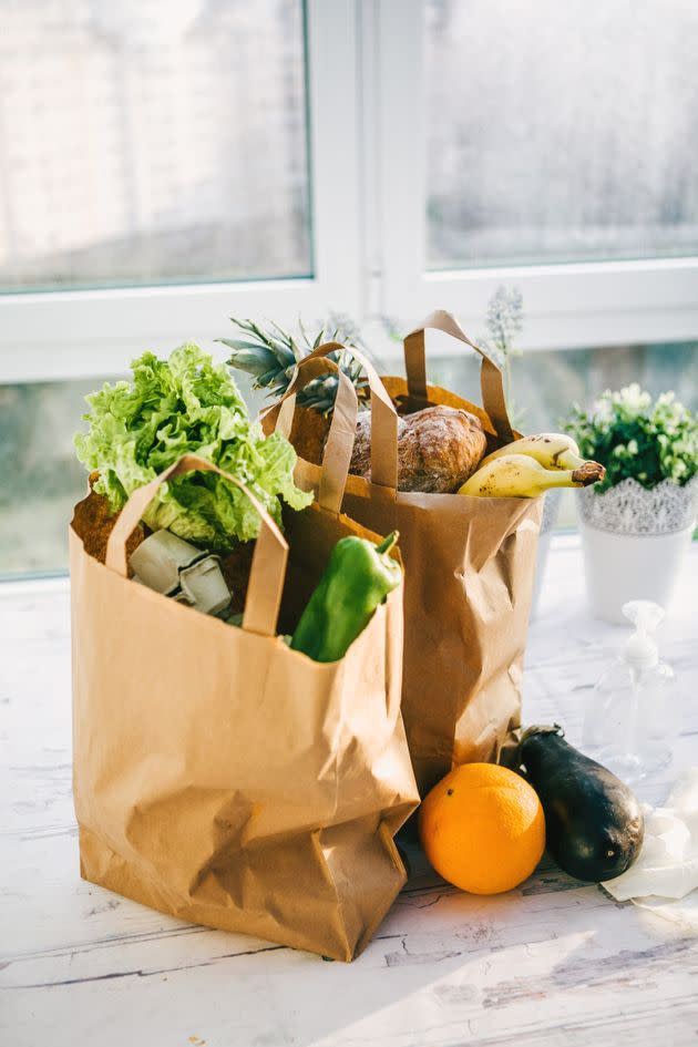 Two grocery bags on a kitchen counter (Photo: Getty)