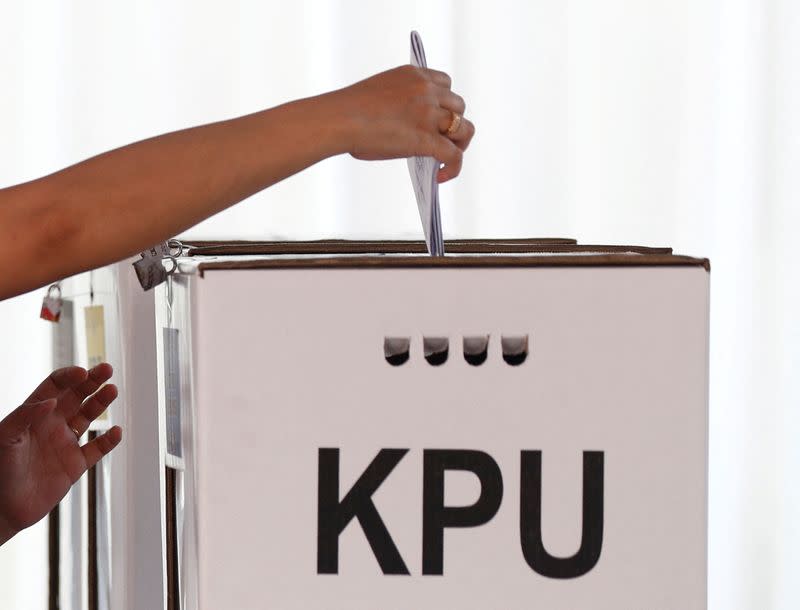 FILE PHOTO: A voter casts a ballot during elections in Jakarta, Indonesia