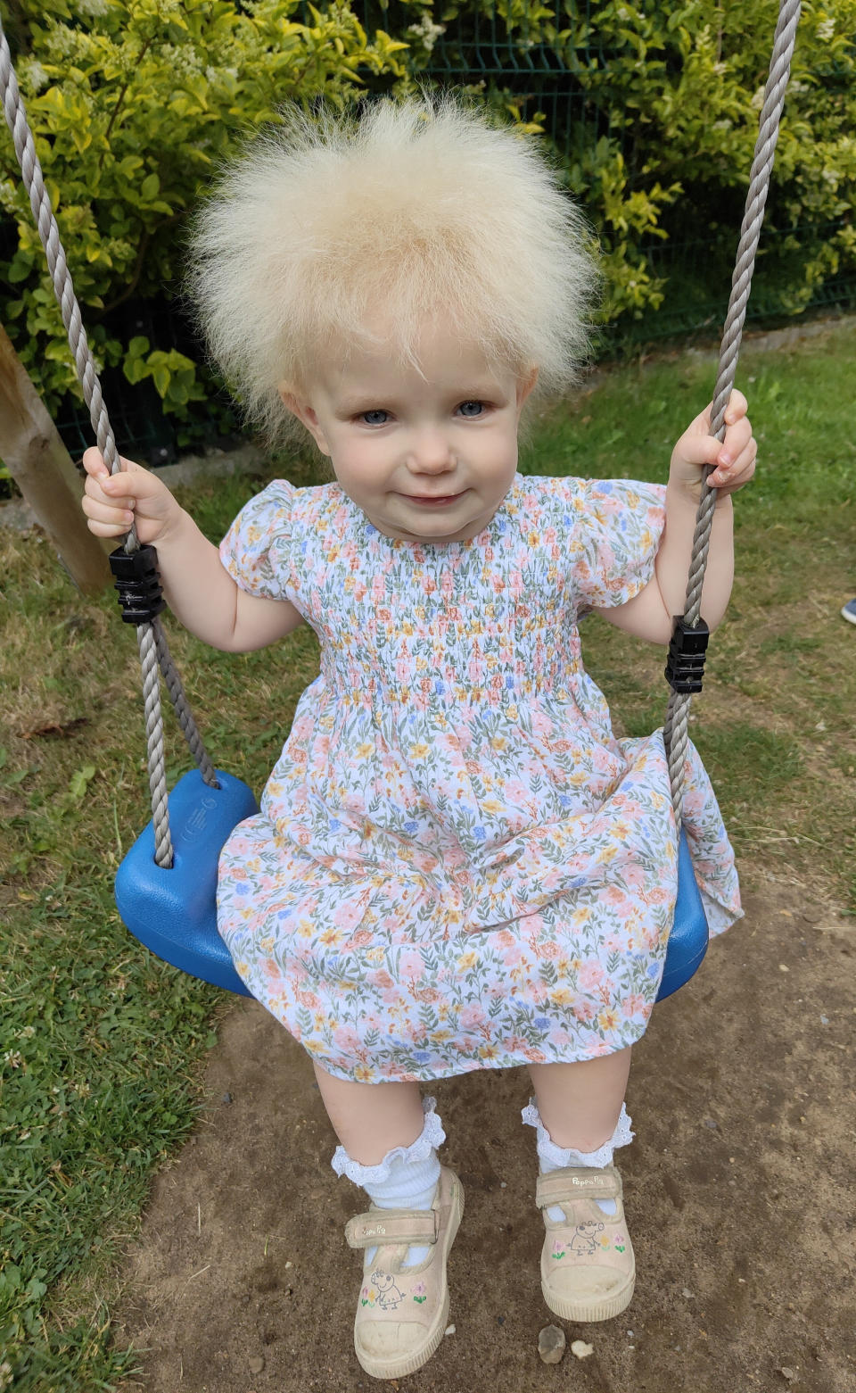 The toddler has blonde locks that defy all attempts to comb them straight (SWNS)