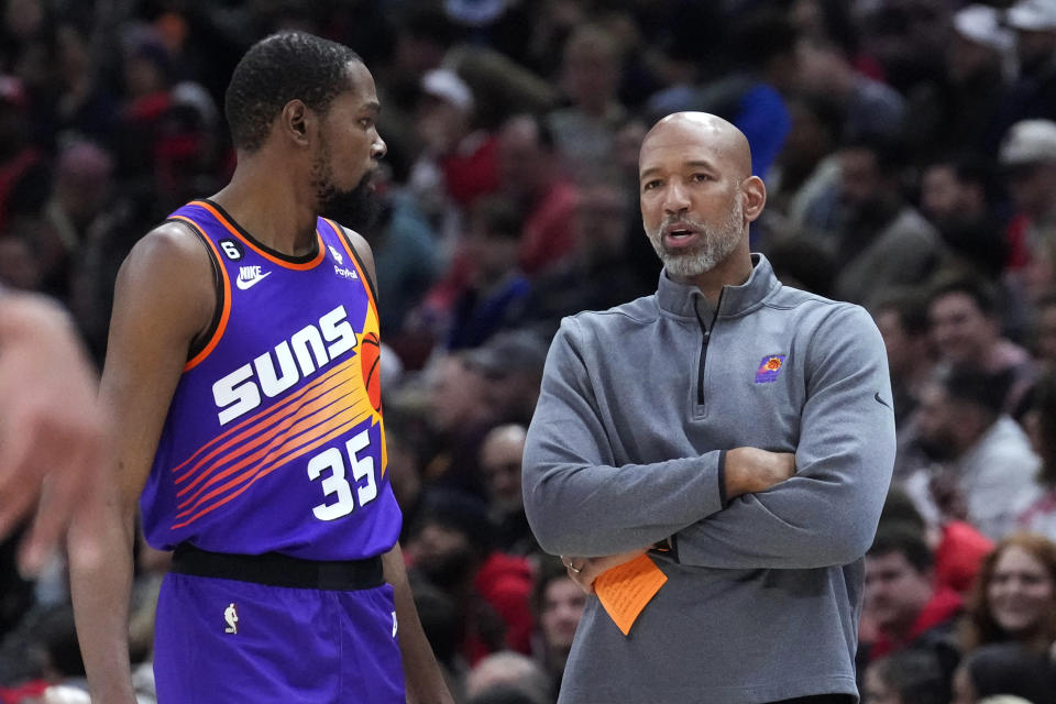 Phoenix Suns coach Monty Williams, right, talks with Kevin Durant during a break in the action in the first half of the team's NBA basketball game against the Chicago Bulls on Friday, March 3, 2023, in Chicago. (AP Photo/Charles Rex Arbogast)