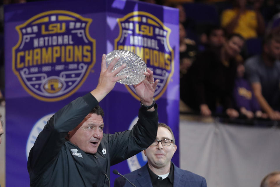 LSU head coach Ed Orgeron holds up the American Football Coaches Association National Championship Trophy during a celebration of their NCAA college football championship, Saturday, Jan. 18, 2020, on the LSU campus in Baton Rouge, La. (AP Photo/Gerald Herbert)