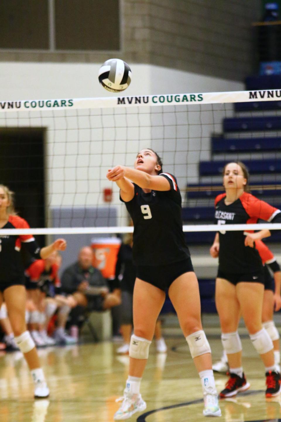Cardington's Jadine Mills bump sets the ball against Pleasant during a Division III volleyball district championship match Saturday night at Mount Vernon Nazarene's Ariel Arena.