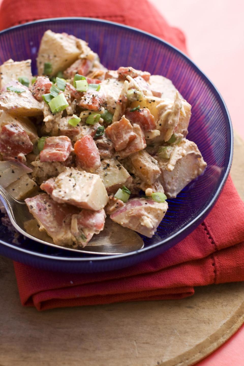 In this image taken on June 3, 2013, three-pepper barbecue potato salad is shown served in a bowl in Concord, N.H. (AP Photo/Matthew Mead)