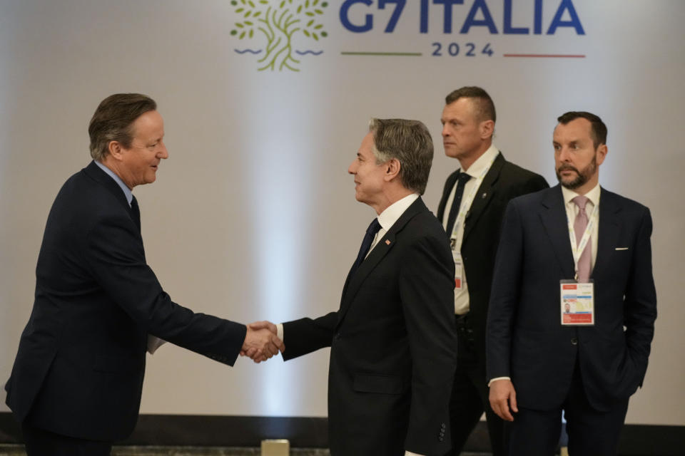 U.S. Secretary of State Antony Blinken, right, shakes hand with Britain's Foreign Secretary David Cameron as they attend an Indo-Pacific meeting on the sidelines of the G7 Foreign Ministers meeting on Capri Island, Italy, Friday, April 19, 2024. (AP Photo/Gregorio Borgia, Pool)