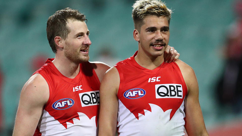 Sydney Swans players Harry Cunningham and Elijah Taylor are pictured walking off the field.