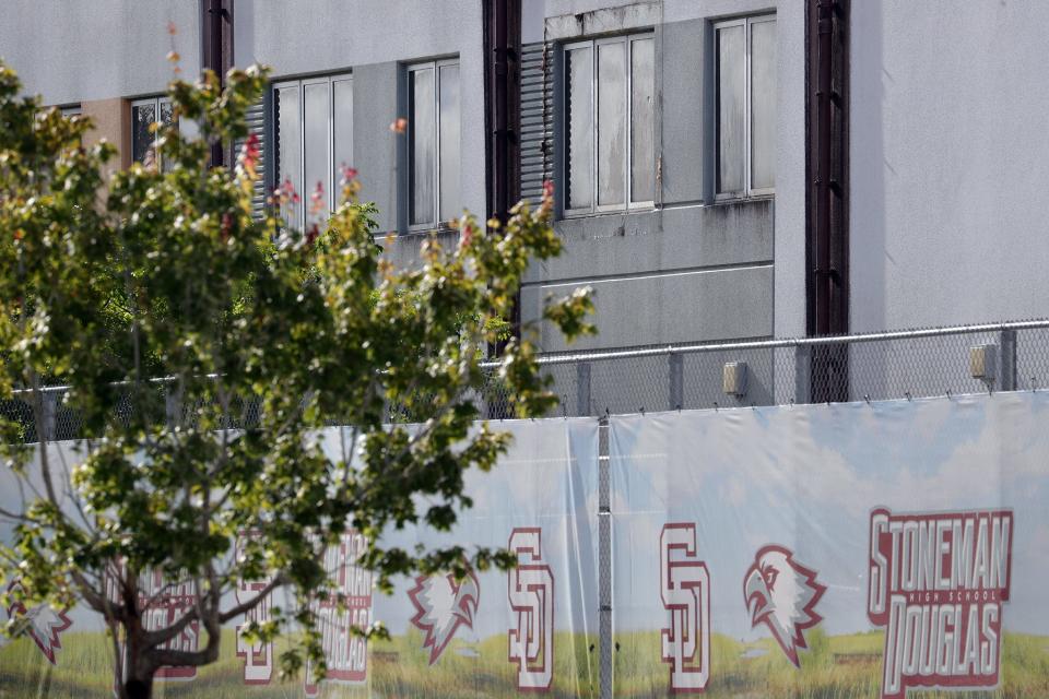 A bullet hole can be seen in a second floor window of the “1200 building,” the crime scene where the 2018 shootings took place, at Marjory Stoneman Douglas High School in Parkland.