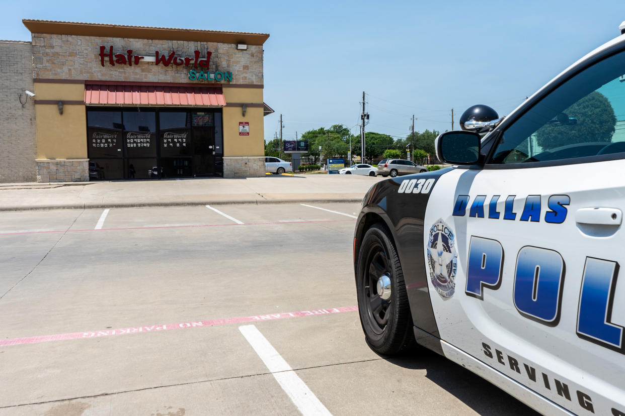 A Dallas police cruiser is stationed outside Hair World Spa on May 14, 2022, where a shooter opened fire and injured three Korean women. (Raul Rodriguez for NBC News)