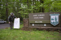 KENMORE, WA - MAY 05: Daryl Kline, a park ranger at Saint Edward State Park removes a sign saying the park is closed on May 5, 2020 in Kenmore, Washington. The first phase to reopen the state begins today easing some restrictions that were put in place during Governor Jay Inslees Stay Home, Stay Healthy order last March to help reduce the spread of COVID-19. Kenmore, WA is located northeast of Seattle. (Photo by Karen Ducey/Getty Images)