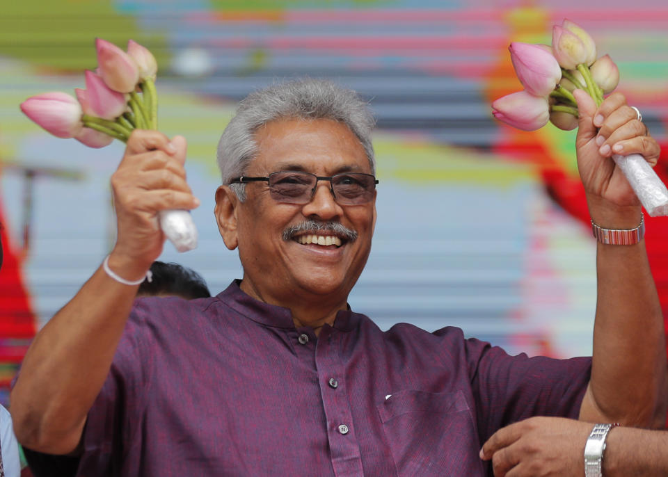 Sri Lankan presidential candidate and former defense chief Gotabaya Rajapaksa waves to his supporters during a rally in Neluwa village in Galle, Sri Lanka, Tuesday, Oct. 22, 2019. Rajapaksa is the front-runner in Sri Lanka's upcoming presidential election. (AP Photo/Eranga Jayawardena)