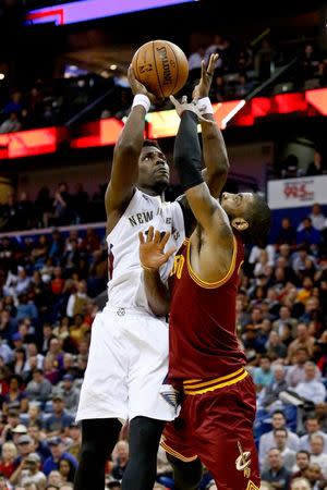 Jan 23, 2017; New Orleans, LA, USA; New Orleans Pelicans guard Jrue Holiday (11) shoots over Cleveland Cavaliers guard Kyrie Irving (2) during the second half of a game at the Smoothie King Center. The Pelicans defeated the Cavaliers 124-122. Mandatory Credit: Derick E. Hingle-USA TODAY Sports