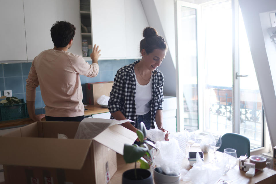 Couple unpacking boxes in their new kitchen