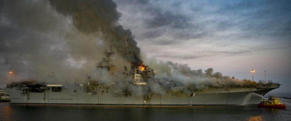 Firefighters battle a fire aboard the US Navy amphibious assault ship USS Bonhomme Richard