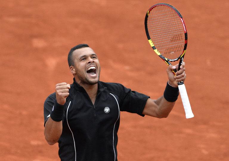 France's Jo-Wilfried Tsonga celebrates after defeating Spain's Pablo Andujar during the men's third round at the Roland Garros 2015 French Tennis Open in Paris on May 29, 2015