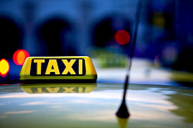 Taxi sign and reflections at night