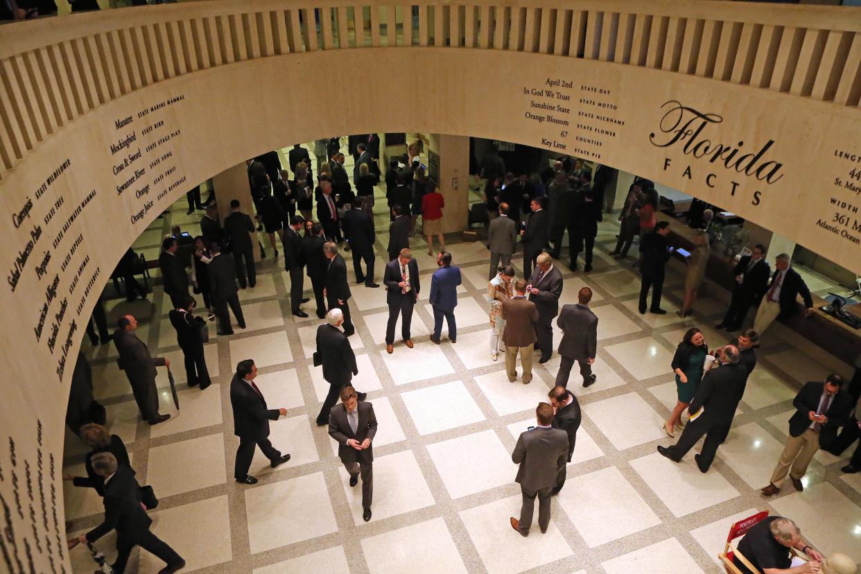 Lobbyists and aides move about the Capitol rotunda in Tallahassee.