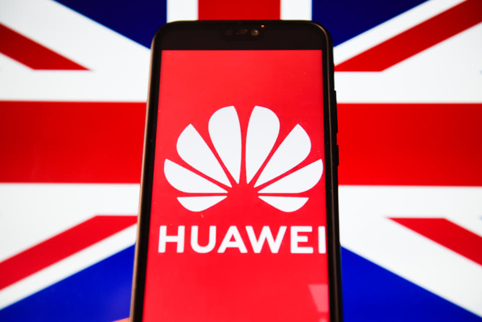 In this photo illustration a Huawei logo seen displayed on a smart phone with United Kingdom flag displayed on a laptop screen. (Photo Illustration by Omar Marques/SOPA Images/LightRocket via Getty Images)