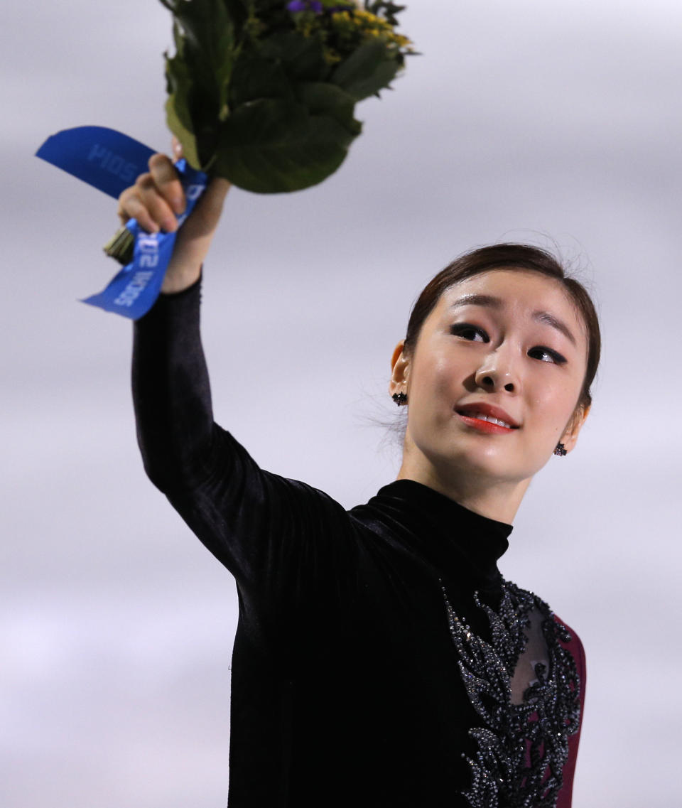 Yuna Kim of South Korea celebrates her second place as she stands on the podium following the women's free skate figure skating finals at the Iceberg Skating Palace during the 2014 Winter Olympics, Thursday, Feb. 20, 2014, in Sochi, Russia. (AP Photo/Vadim Ghirda)