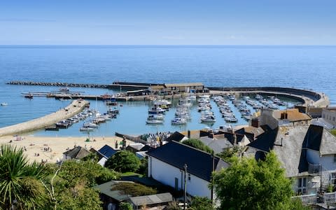 views over Lyme Regis harbour - Credit: Getty