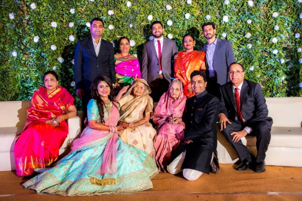 The bride and groom with his family. [Photo: hocusfocuscaptures]