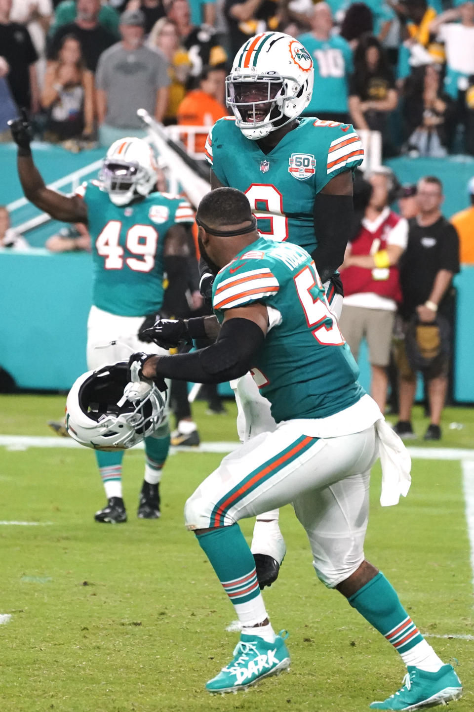 Miami Dolphins cornerback Noah Igbinoghene (9) celebrates after intercepting a pass during the second half of an NFL football game against the Pittsburgh Steelers, Sunday, Oct. 23, 2022, in Miami Gardens, Fla. The Dolphins defeated the Steelers 16-10. (AP Photo/Wilfredo Lee )