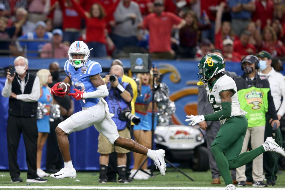 Mississippi Rebels wide receiver Braylon Sanders (13) outruns Baylor Bears cornerback Kalon Barnes (12) to the end zone for a touchdown in the third quarter of the 2022 Sugar Bowl on Jan. 1 at the Caesars Superdome. Sanders is an undrafted free agent signee of the Dolphins.