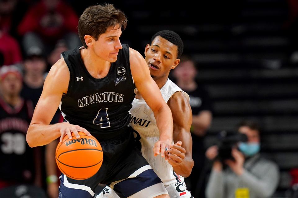 Cincinnati Bearcats forward Ody Oguama (33) defends on Monmouth Hawks forward Walker Miller (4) in the first half of an NCAA men's college basketball game, Saturday, Nov. 27, 2021, at Fifth Third Arena in Cincinnati.