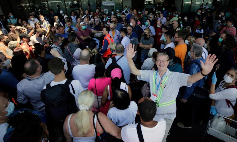 German humanitarian volunteer Max Motschmann (right) gestures as he gathers his fellow countrymen to board a Lufthansa repatriation flight in Manila.