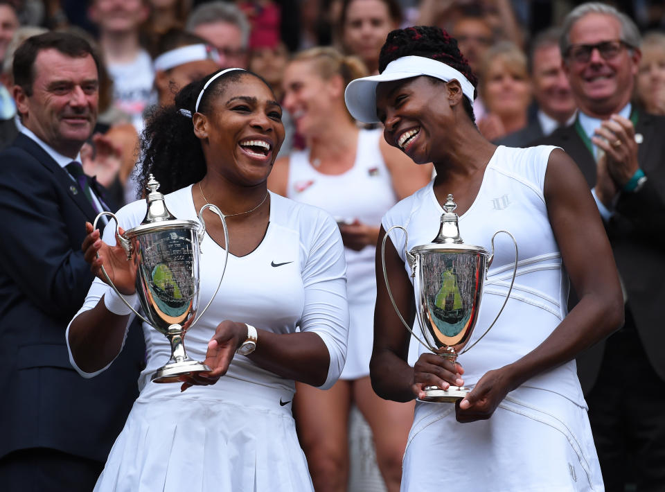 Pictured left to right, Serena and Venus Williams with their 2016 Wimbledon doubles winner's trophy.