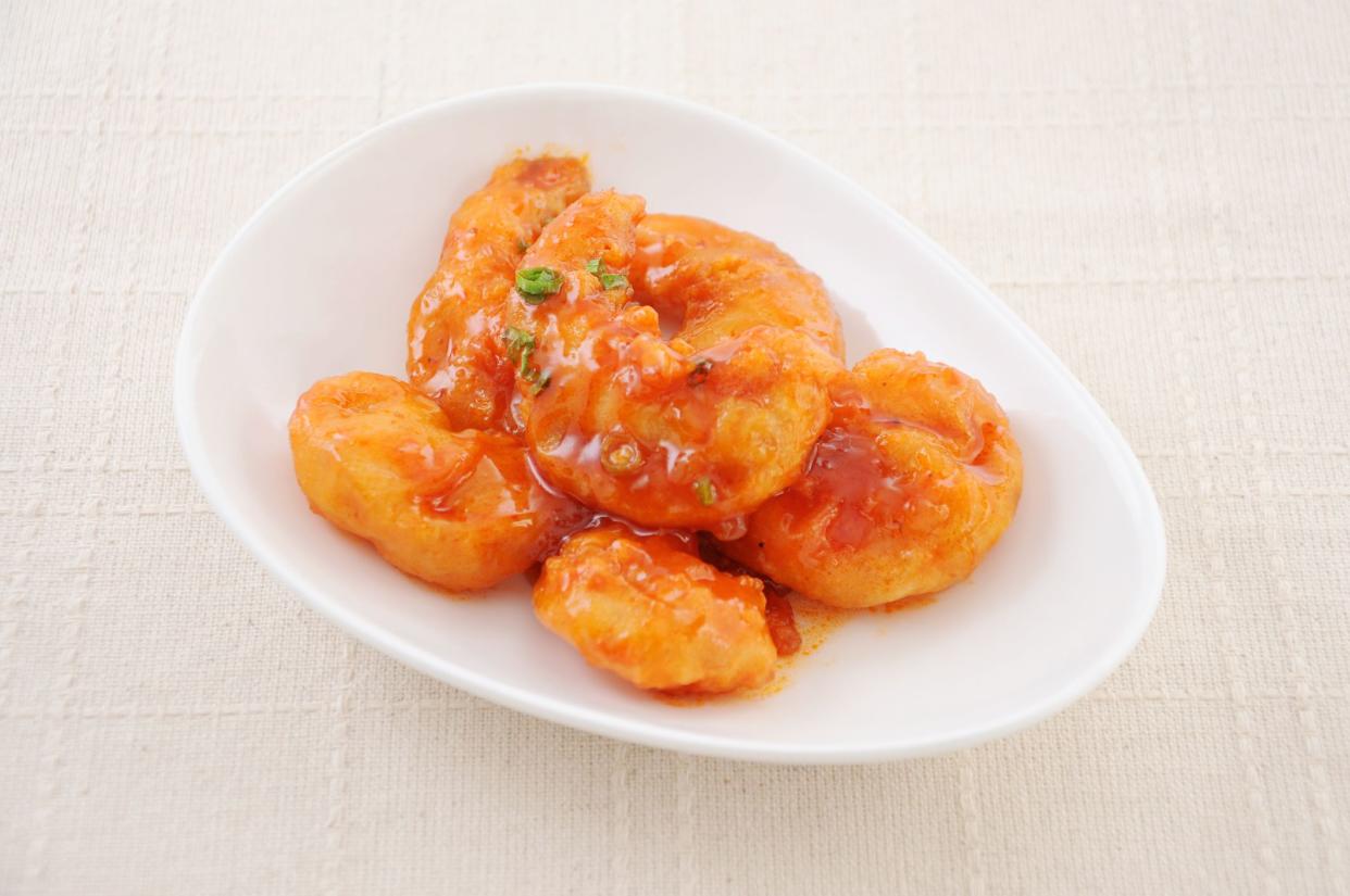 stir-fried shrimp in chili sauce Chinese dish on plate on table