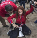 Jennifer Sterling, one of the organizers of the pro-Donald Trump rally reacts after getting hit with pepper spray in Huntington Beach, Calif., on Saturday, March 25, 2017. Violence erupted when a march of about 2,000 Trump supporters at Bolsa Chica State Beach reached a group of about 30 counter-protesters, some of whom began spraying pepper spray, said Capt. Kevin Pearsall of the California State Parks Police. (Mindy Schauer/The Orange County Register via AP)