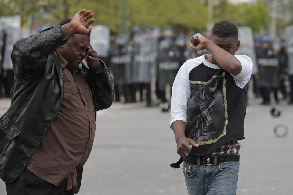 BALTIMORE, MD - APRIL 27:  Demonstrators wipe pepper spray out of their eyes near the Mondawmin Mall during violent protests following the funeral of Freddie Gray April 27, 2015 in Baltimore, Maryland. Gray, 25, who was arrested for possessing a switch blade knife April 12 outside the Gilmor Homes housing project on Baltimore's west side. According to his attorney, Gray died a week later in the hospital from a severe spinal cord injury he received while in police custody.  (Photo by Chip Somodevilla/Getty Images)