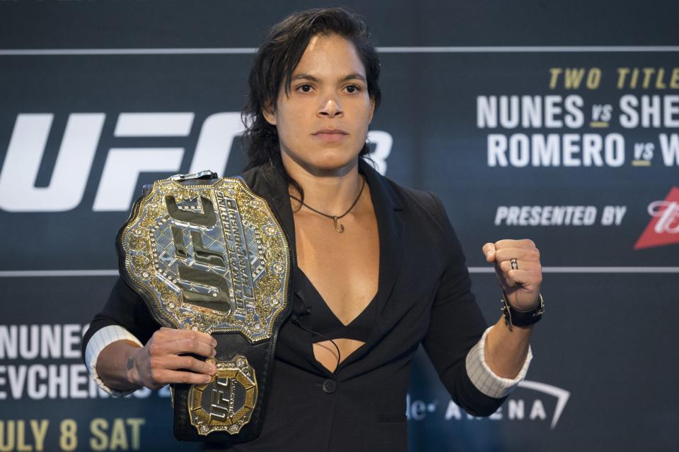 Amanda Nunes, here posing before a fight in 2017, became the first UFC fighter to defend two championship belts while actively holding the titles in both weight classes Saturday night.