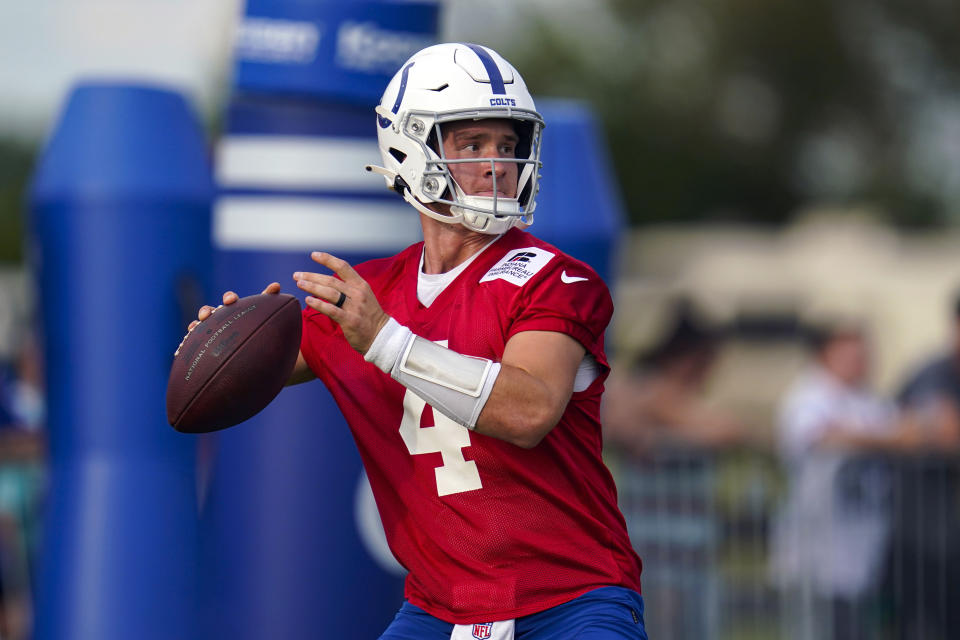 FILE -Indianapolis Colts quarterback Sam Ehlinger throws during practice at the NFL team's football training camp in Westfield, Ind., Saturday, July 30, 2022. The Indianapolis Colts and Washington Commanders thought Matt Ryan and Carson Wentz would be the feature attractions in Sunday's game. Turns out, they've been replaced. Washington's Taylor Heinicke and Indy's Sam Ehlinger will be have the feature roles.(AP Photo/Michael Conroy, File)