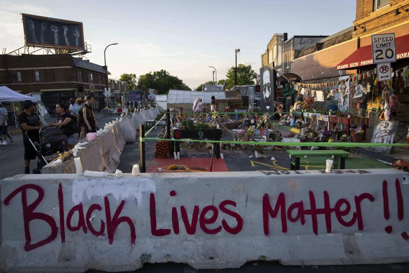 Jersey barriers placed by the city of Minneapolis surround memorials as community members gather in George Floyd Square to demand justice for Winston Boogie Smith Jr., on Monday, June 7, 2021. (AP Photo/Christian Monterrosa)