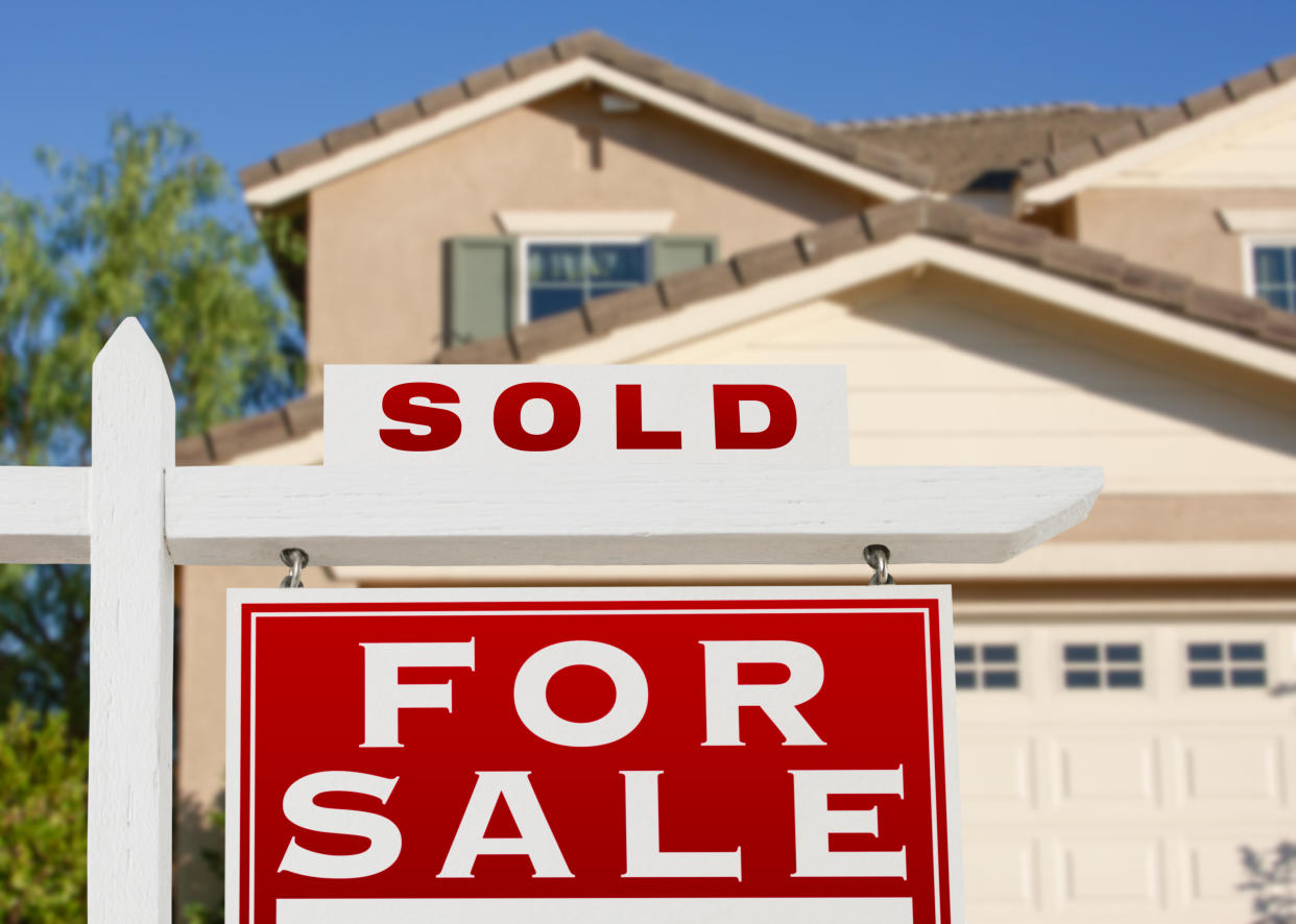 Sold Home For Sale Real Estate Sign and House.