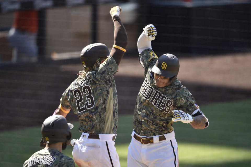 San Diego Padres' Manny Machado, right, celebrates with Fernando Tatis Jr. after hitting a two-run home run during the eighth inning of a baseball game against the Houston Astros in San Diego, Sunday, Aug. 23, 2020. (AP Photo/Kelvin Kuo)