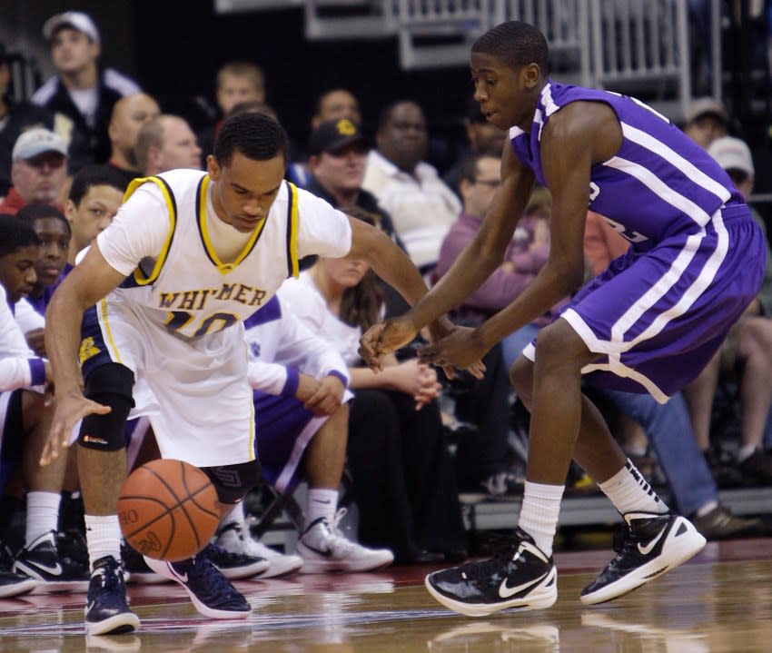 Pickerington’s Caris Levert, right, knocks the ball away from Toledo Whitmer’s Ricardo Smith during the first quarter of the OHSAA Division I high school basketball championship game Saturday, March 24, 2012, in Columbus, Ohio. (AP Photo/Jay LaPrete)