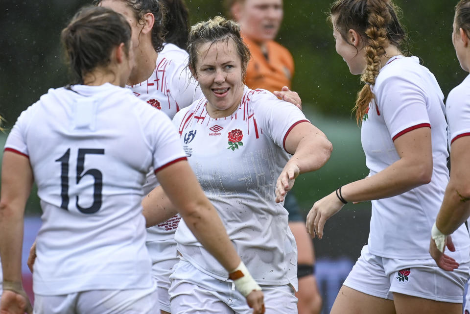 England's Marlie Packer, centre, is congratulated by teammates after scoring a try during the women's rugby World Cup quarterfinal against Australia at Waitakere Stadium in Auckland, New Zealand, Sunday Oct. 30 2022. (Andrew Cornaga/Photosport via AP)