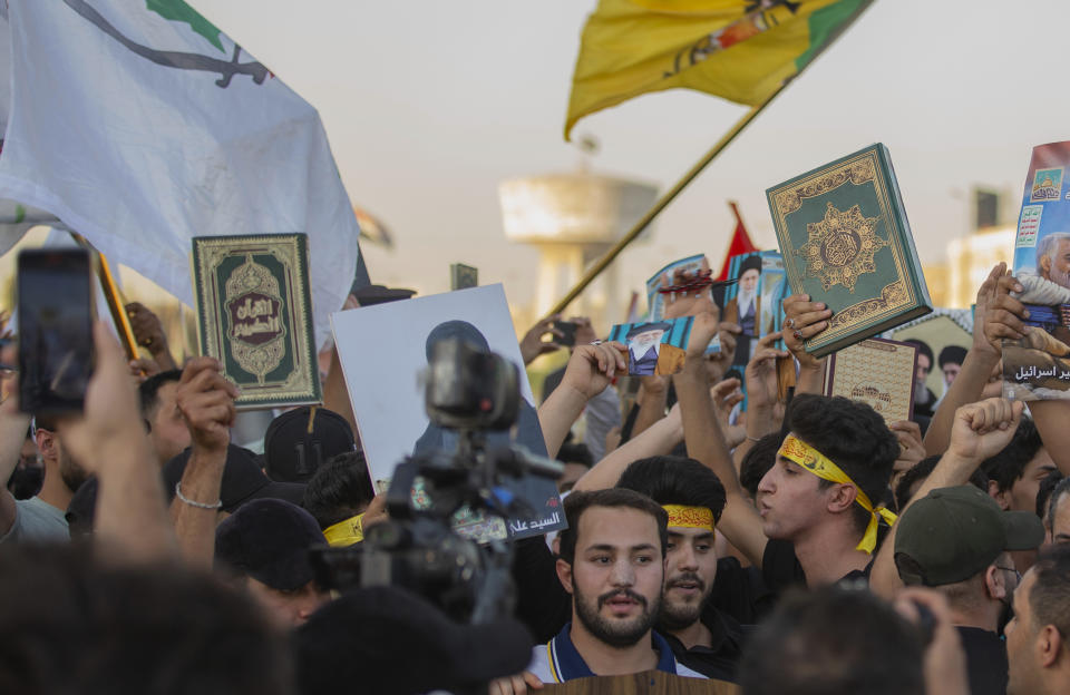 Iraqis raise copies of the Quran, Muslims' holy book, during a protest in Tahrir Square, Thursday، July 20, 2023 in Baghdad, Iraq. The protest was in response to the burning of Quran in Sweden. (AP Photo/Adil AL-Khazali)