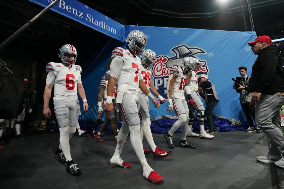 Dec 31, 2022; Atlanta, Georgia, USA; Ohio State Buckeyes quarterback C.J. Stroud (7) walks to the field for warm ups prior to the Peach Bowl against the Georgia Bulldogs in the College Football Playoff semifinal at Mercedes-Benz Stadium. Mandatory Credit: Adam Cairns-The Columbus Dispatch