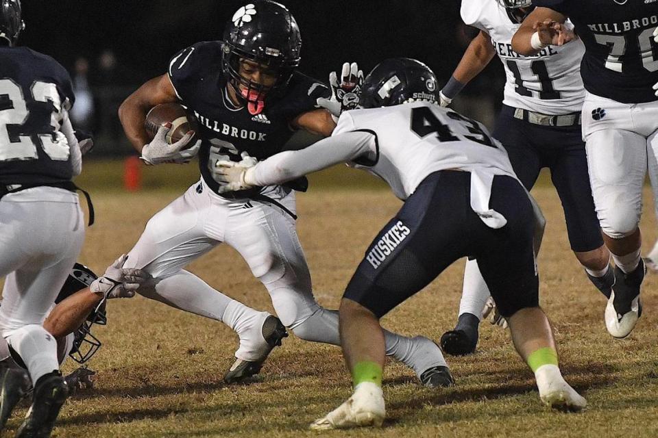 Millbrook’s Nessiah McArthur (6) runs for yardage against Heritage’s Chandler Fleming (43) during the first half. The Millbrook Wildcats and the Heritage Huskies met in a NCHSAA 4A playoff first round game in Raleigh, N.C. on November 3, 2023.